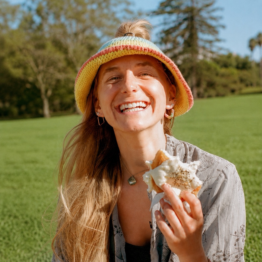 Smiling in a crochet HolyHat, top-knot through the crown